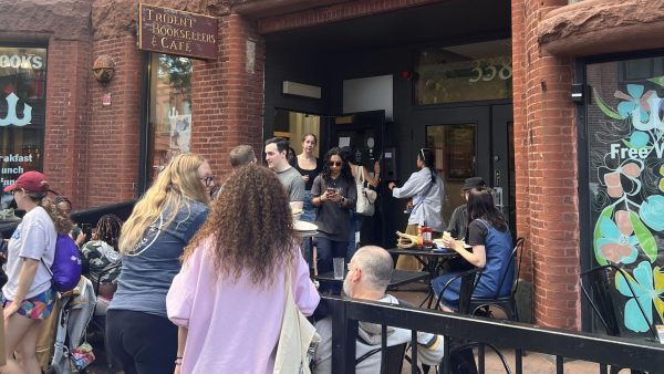 Attendees walk in and out of the Trident Bookstore anniversary party. Many enjoyed snacking on refreshments and reading books during the event.