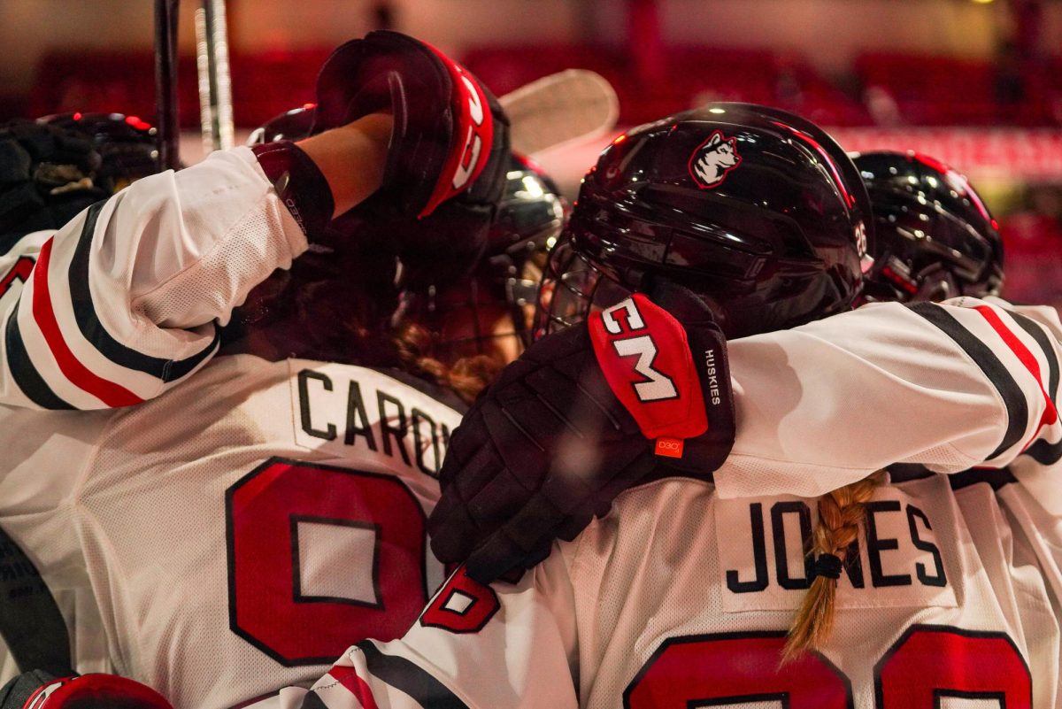 Northeastern embraces after adding another goal over BU in the 4-0 shutout Oct. 11. Rookie Éloïse Caron tallied two of Northeastern's goals.