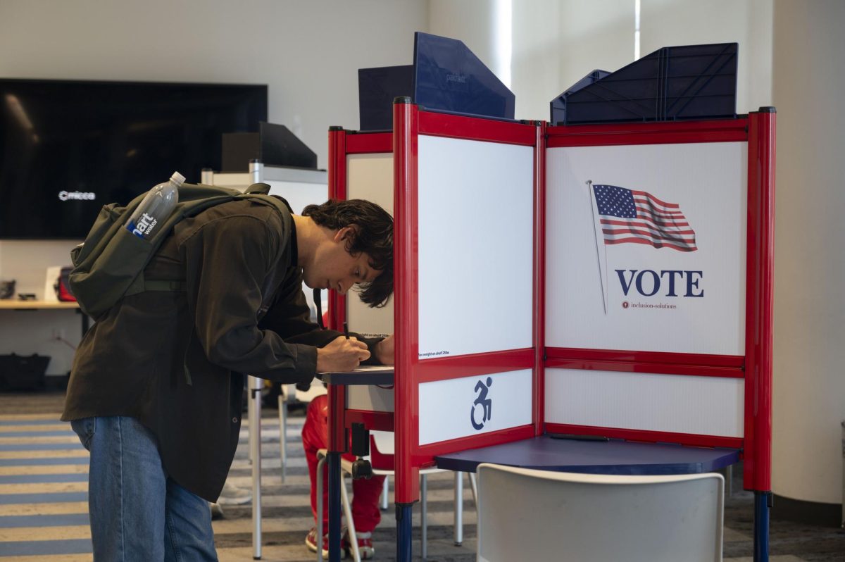 A voter fills out his ballot at the Northeastern Crossing voting location. There were 22 precincts across the city.