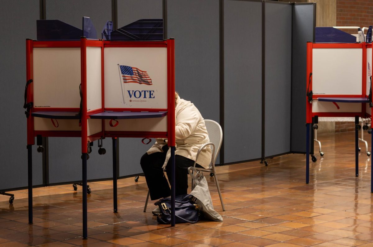 A voter sits and completes her ballot. The warden and clerks helped citizens and guided them to their designated voting locations.