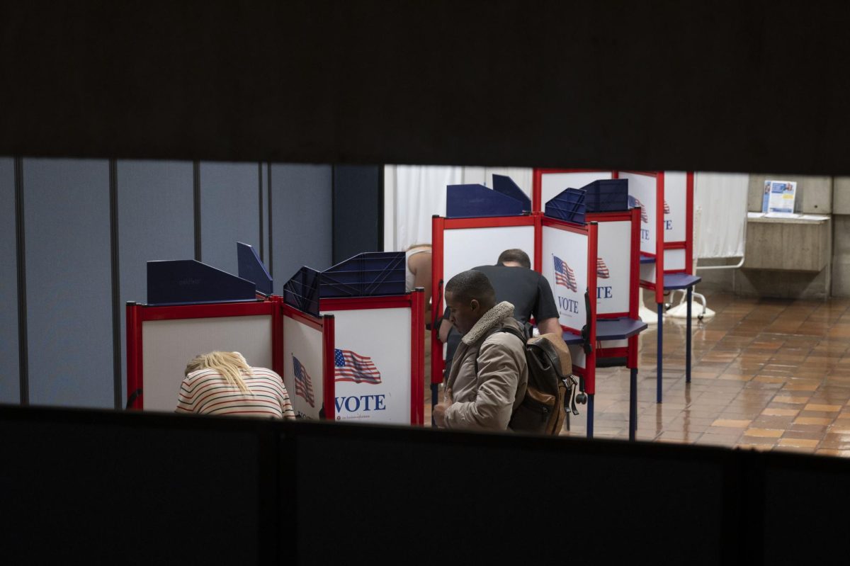 Voters fill out their ballots in City Hall. Some Boston locations experienced a shortage of ballots due to high voter turnout.