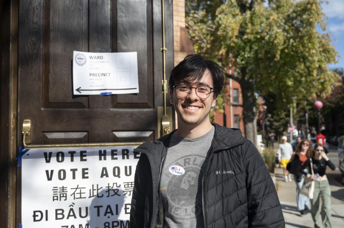 Shai Mann-Robison, a 22-year-old programmer and recent Northeastern graduate, poses for a photo at the entrance to the Fenway Center. This year’s election was his first time voting.