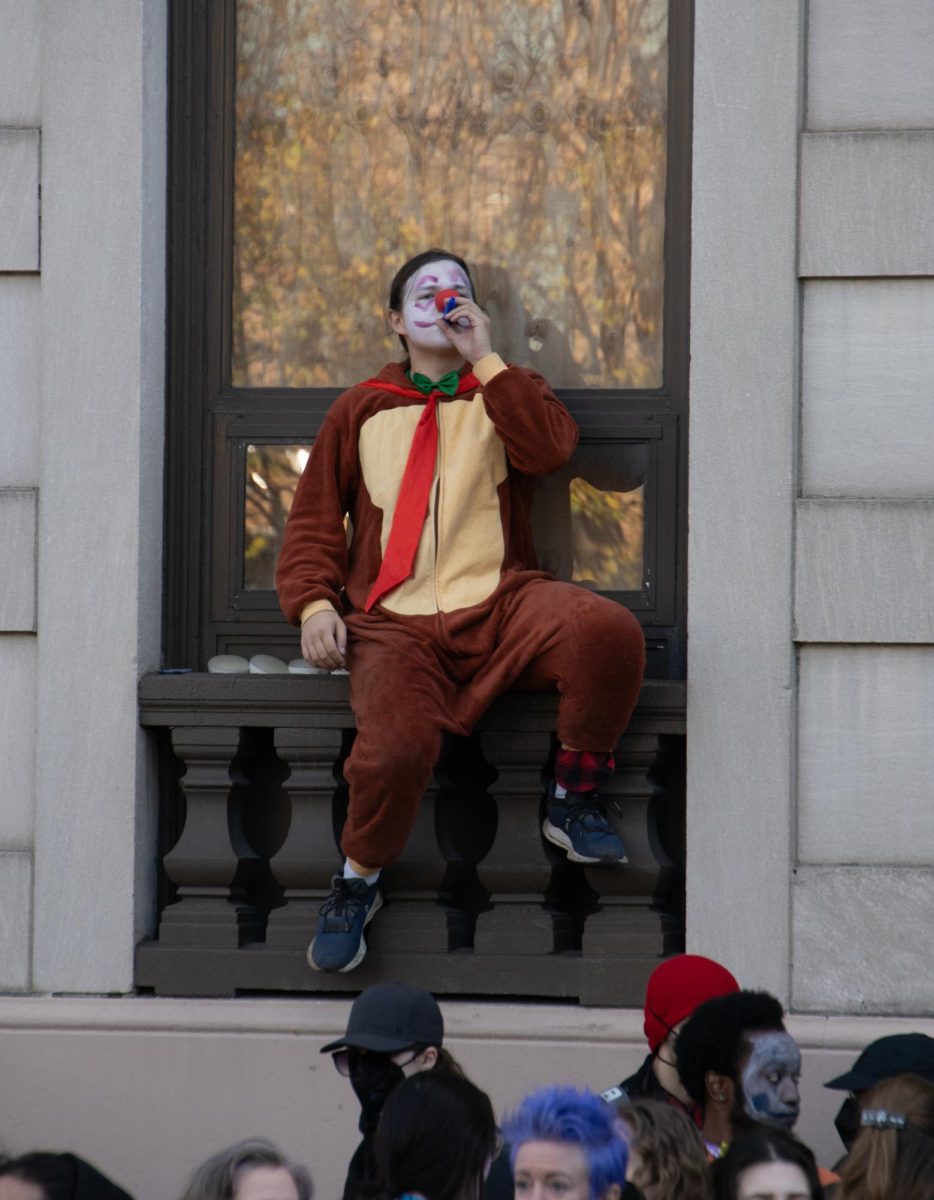 A counterprotester dressed as a clown plays the kazoo to drown out chanting from the Men’s March. Members of a brass band accompanied the “clownterprotesters” as they walked alongside the Men’s March, playing loud covers of songs like “Pop Goes The Weasel” to mock the anti-abortion activists.