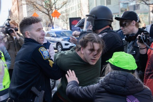 A legal observer from the NLG asks an arrested counterprotester for their personal information as BPD officers take them to a prisoner transport van. Over a dozen NLG legal observers jotted down notes throughout the day’s activities and shouted their bail fund phone number to arrestees.