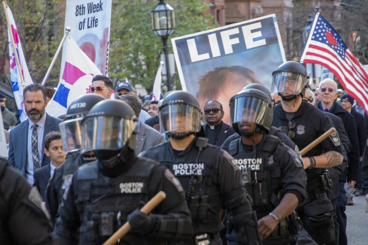 BPD officers in riot gear escort the Men’s March down Commonwealth Avenue. Anti-abortion activists carried large posters purporting to show graphic images of aborted fetuses, religious iconography and pro-life flags.