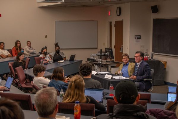 Arnon Mishkin (left) and Costas Panagopoulos speak about the presidential election results to a crowd in Shillman Hall. The two recapped factors that led to Donald Trump's victory, and answered student questions about the election results.