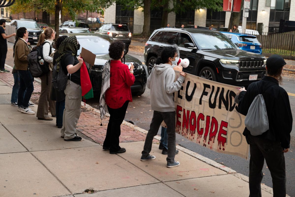 Pro-Palestine demonstrators chant and hold up signs outside an apartment building on Hemenway Street. The protest was meant to disrupt the visit of two IDF soldiers who came to speak at an event hosted by Northeastern Mishelanu.