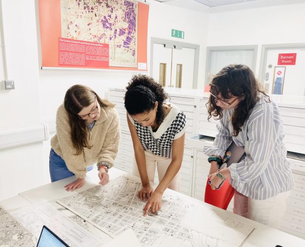 Libby Collard, Odile Jordan and Ellen Valente (left to right)examine a map of London at the London Archives in 2022. Detailed maps revealed not only locations of Black communities and borders, but also hidden cultures. Photo courtesy Oliver Ayers.