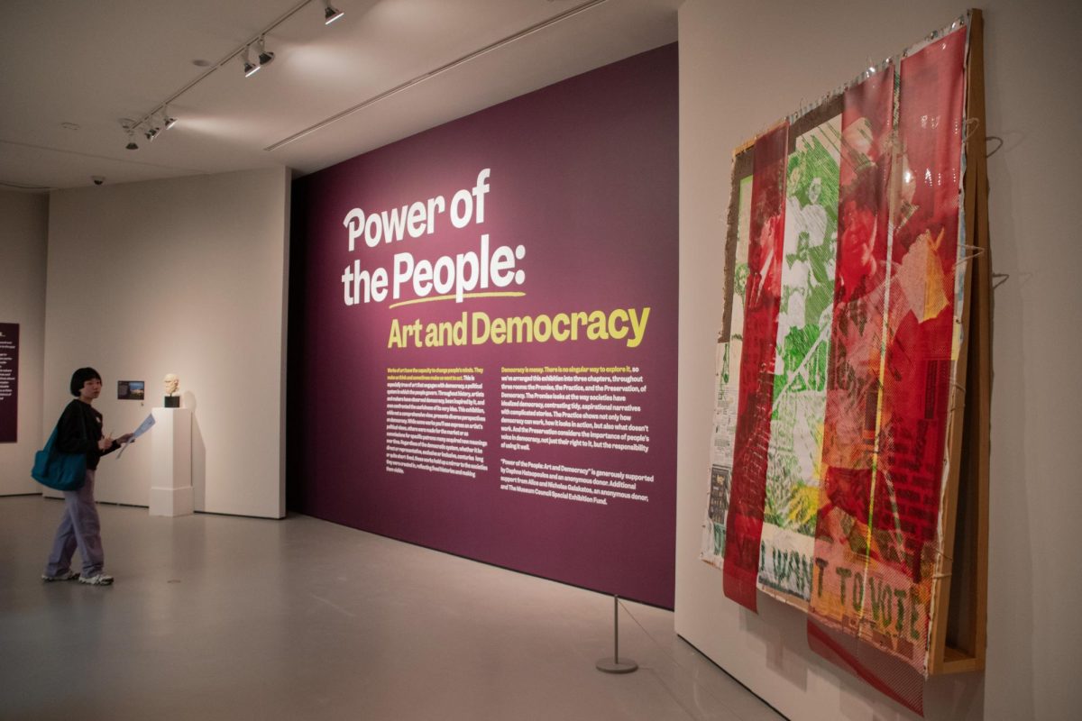 Text on an exhibit wall reads "Power of the People: Art and Democracy." The exhibit contained pieces that explored the idea of democracy through three themes, the Promise, the Practice and the Preservation.