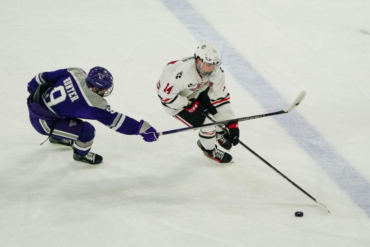 Joe Connor reaches for the puck against Stonehill College Oct. 12. The freshman was drafted in the seventh round of the 2024 NHL draft to the Tampa Bay Lightning.