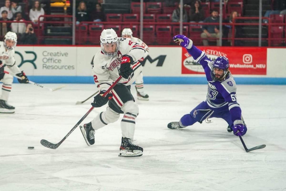 Borgesi looks to strike the puck against Stonehill Oct. 12. The assistant captain ranked fifth among all defensemen in Hockey East last season.