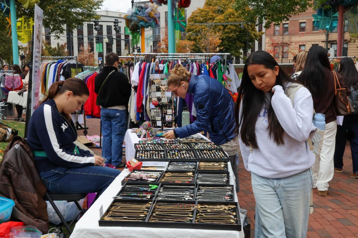 Students inspect secondhand jewelry. While most vendors sold clothes, a few featured accessories such as rings, necklaces and purses.