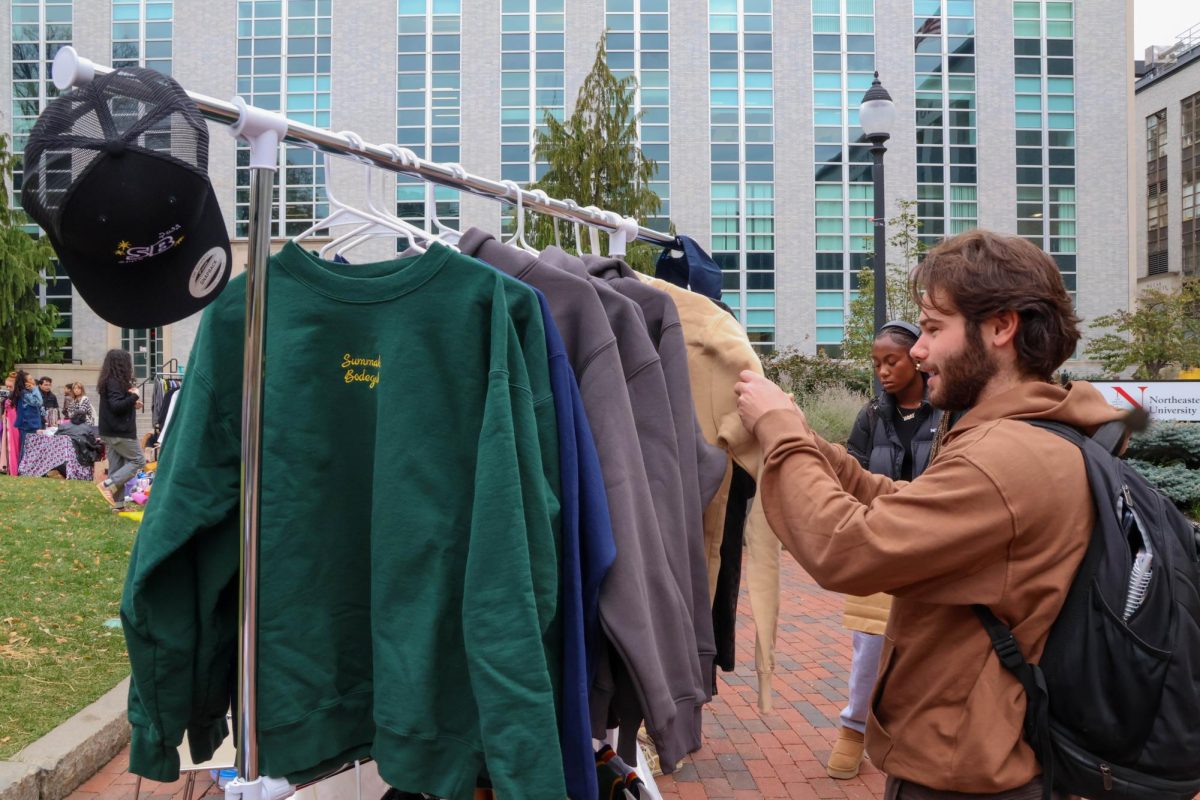 A student browses through second-year business administration major Alexander El-Ghadi’s personal brand, Summah Bodegah. El-Ghadi founded his own streetwear line of comfy crewnecks, embroidered hoodies, shirts and hats.