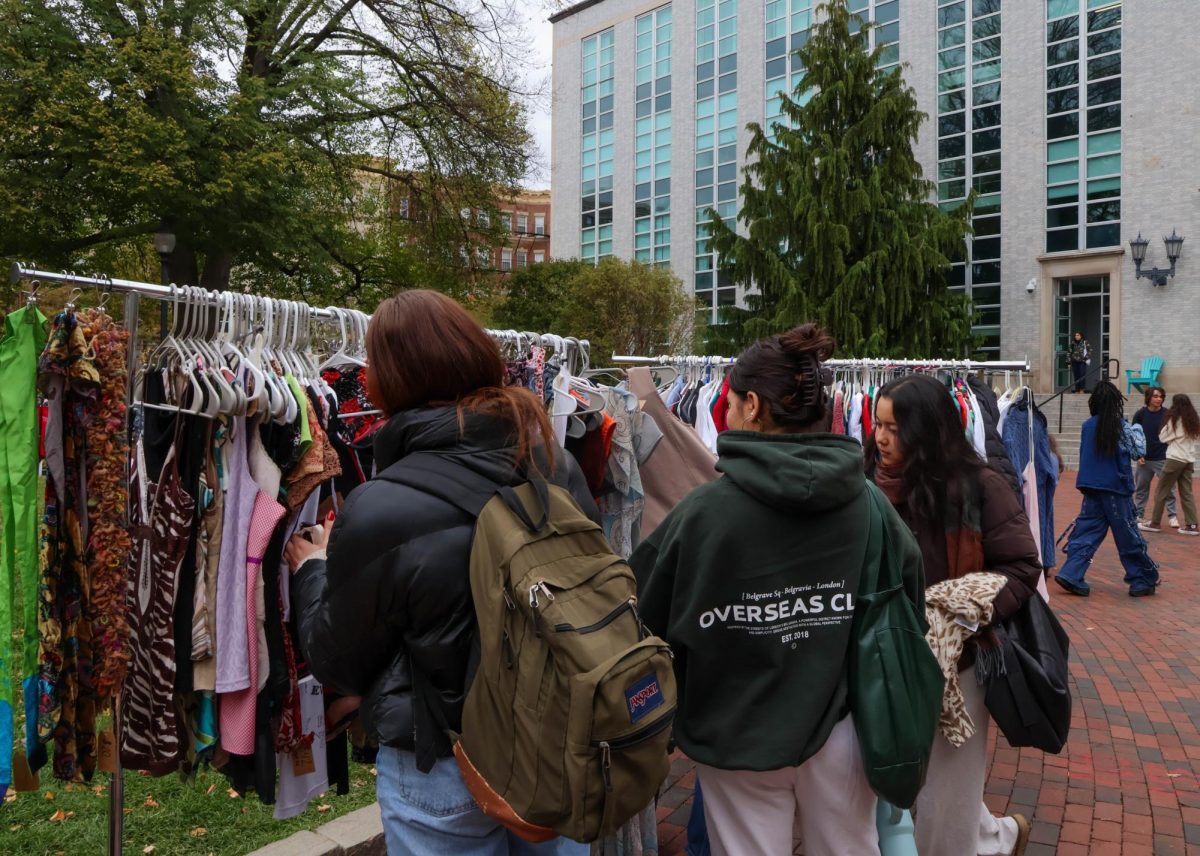 Students sift through clothing racks, looking to purchase used items. Vendors started the day with full clothing racks that became progressively bare by 5 p.m.