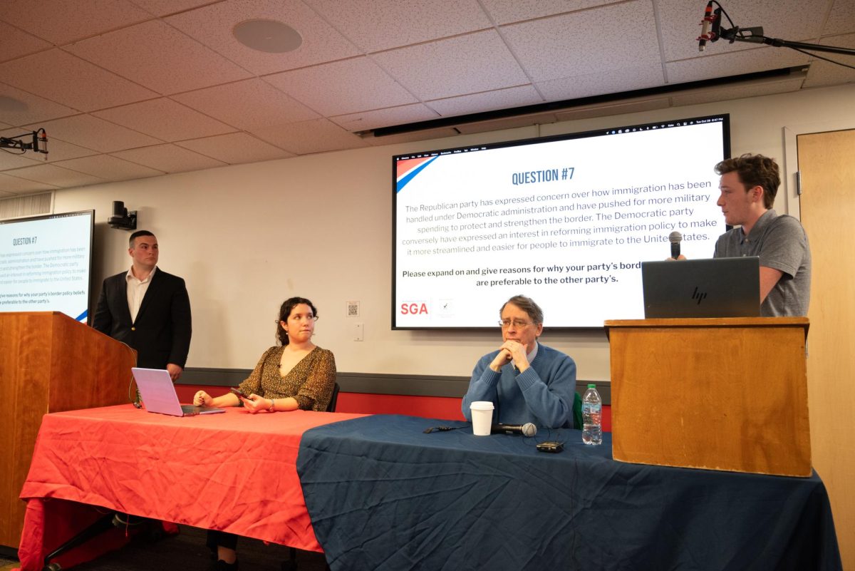 Matt Cosentino, Kate Mittelhauser, William Mayer and Will Burke (left to right) participate in the presidential debate between Northeastern’s College Republicans and College Democrats. Topics discussed included the size of the government, climate change, abortion and the presidential candidates.