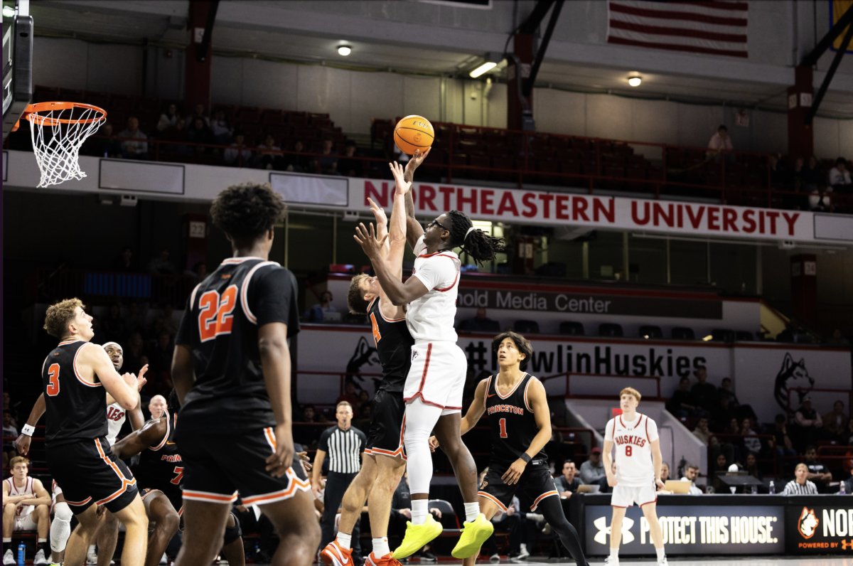 Harold Woods jumps for the shot over Princeton Nov. 10. The Husky tallied a game-high 27 points in the matchup.