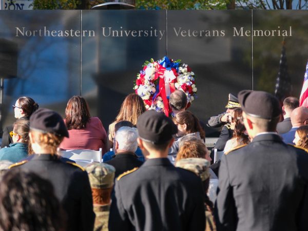 People sit during Northeastern’s Veteran’s Day ceremony. The event honored those who lost their lives and celebrated alumni and student veterans.