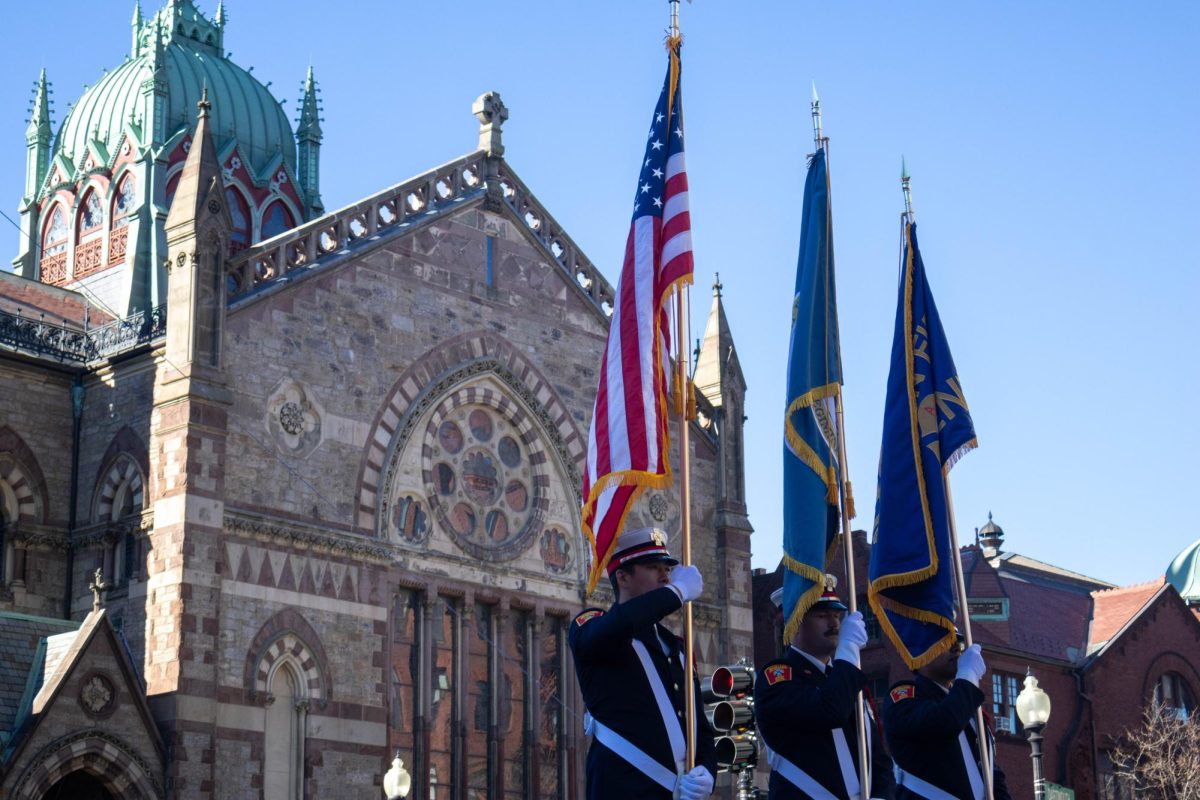 Members of the military carry flags as they pass the Old South Church. The American, city of Boston and Boston Fire Department flags (left to right) were featured. 