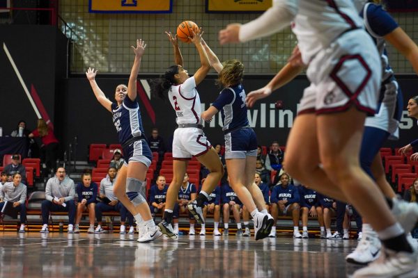 Abby Jegede fights for possession of the ball over the University of New Hampshire Nov. 14. The Husky notched a team-high 12 points in the game.