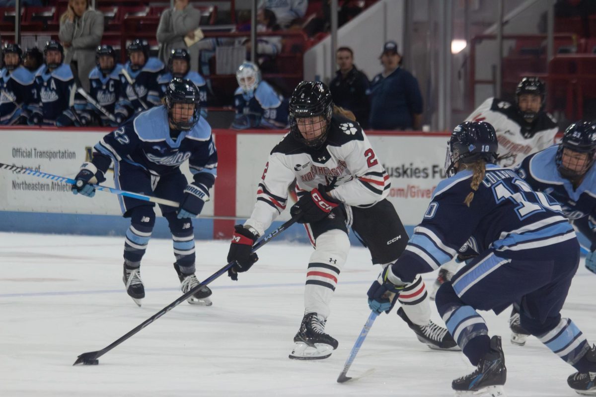 Lily Shannon maintains possession of the puck over Maine Nov. 15. The Husky tallied both Northeastern goals in the 2-1 victory.