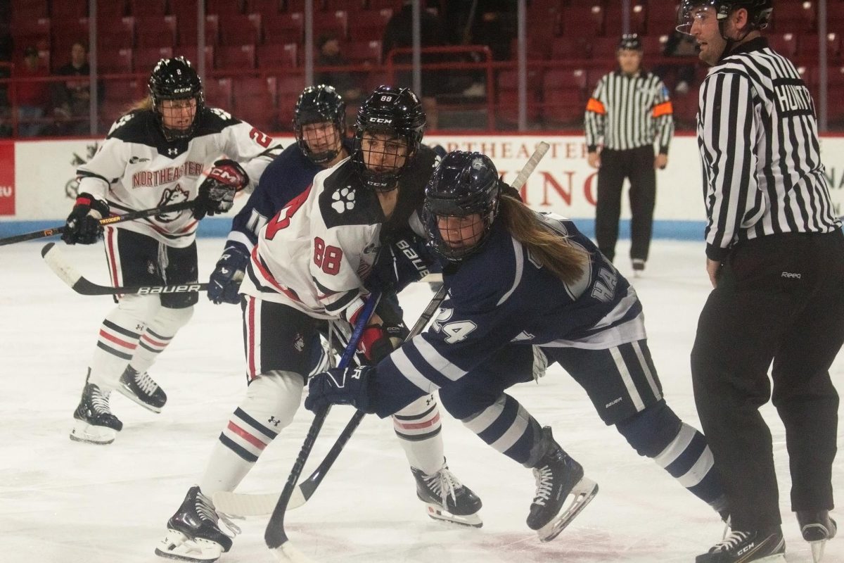 Skylar Irving battles for the puck against UNH Oct. 9. The Huskies tallied just three shots compared to the Wildcats's five in the 2-0 loss.