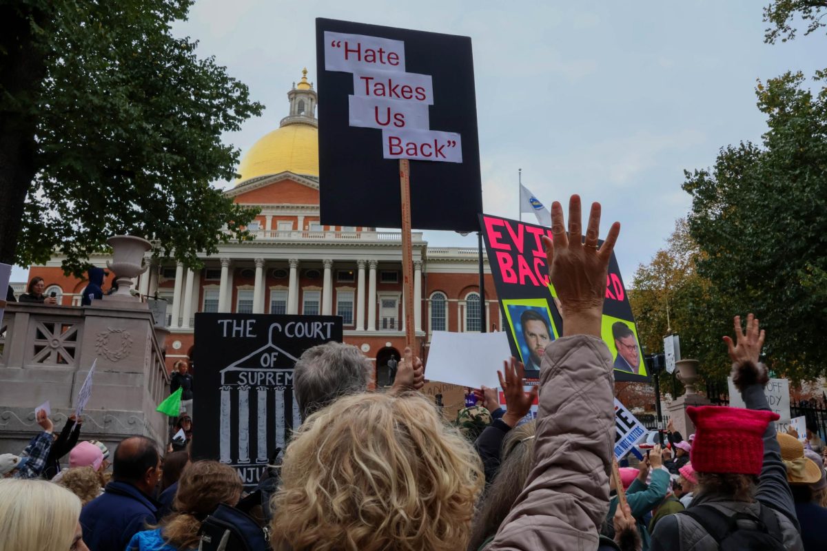 Protesters at the Nov. 2. Boston Women’s March rally and hold up signs. Demonstrators protested the reelection of Donald Trump and the threats he would pose to women's rights.