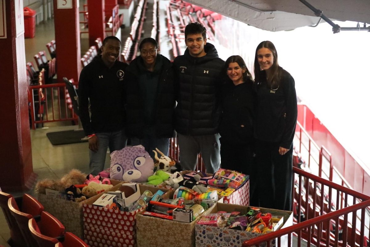 The SAAC executive team stands next to their donations before dropping them off to the Wonderfund. The committee collected 321 toys this year. Photo courtesy Northeastern Athletics.