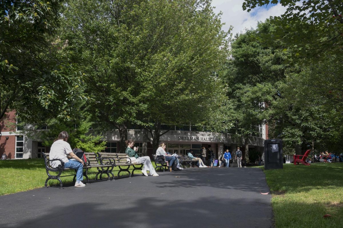 Students sit along a line of benches in the Centennial Common greenery. Many who voted in the November election did not consider climate to be their top priority, despite the increase of weather disasters such as Hurricane Milton.