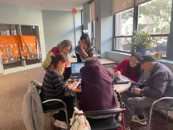 Ka Yat Michelle Lau and other volunteers at LBFE help teach senior citizens how to use various technological programs. A rise in online platforms made for keeping track of healthcare services increased the digital divide for many elderly people. Photo courtesy Chisom Nnajiofor. 