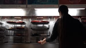 A student places their plate on the rotating dishwasher racks at Stetson East. Swipe2Care was established in 2018, allowing students to donate three unused meal swipes a week.