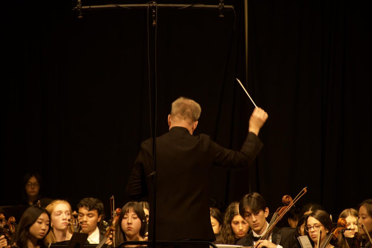 NUSO conductor Evan Bennett orchestrates the first piece of the concert, “Overture To The Wreckers.” Orchestra members followed his lead closely as the concert unfolded.