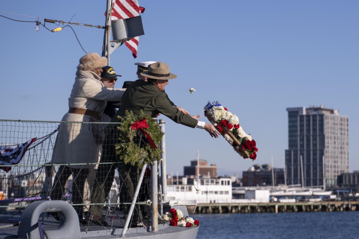 Michael Creasey, Andrea Gayle-Bennett, Robert Santiago and Crystal Schaefer, commander of the USS Constitution, toss a ceremonial wreath into the harbor. The ceremony honored the men and women who lost their lives during the Pearl Harbor attacks.