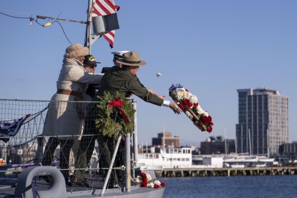 Michael Creasey, Andrea Gayle-Bennett, Robert Santiago and Crystal Schaefer, commander of the USS Constitution, toss a ceremonial wreath into the harbor. The ceremony honored the men and women who lost their lives during the Pearl Harbor attacks.