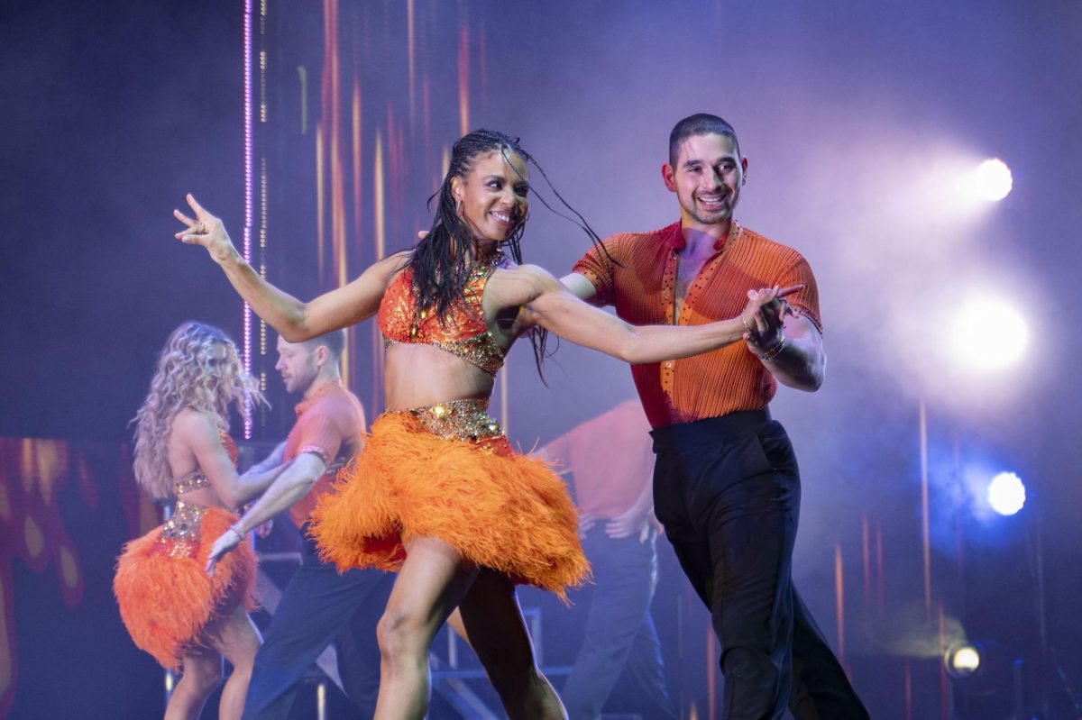 Britt Stewart and Alan Bersten perform for the audience. The opening dance featured flashy orange costumes with sequins.