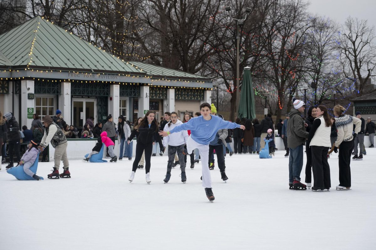 Bostonians skate on the Boston Common frog pond. Hundreds showed up with friends and family to enjoy the winter tradition despite the gloomy weather.