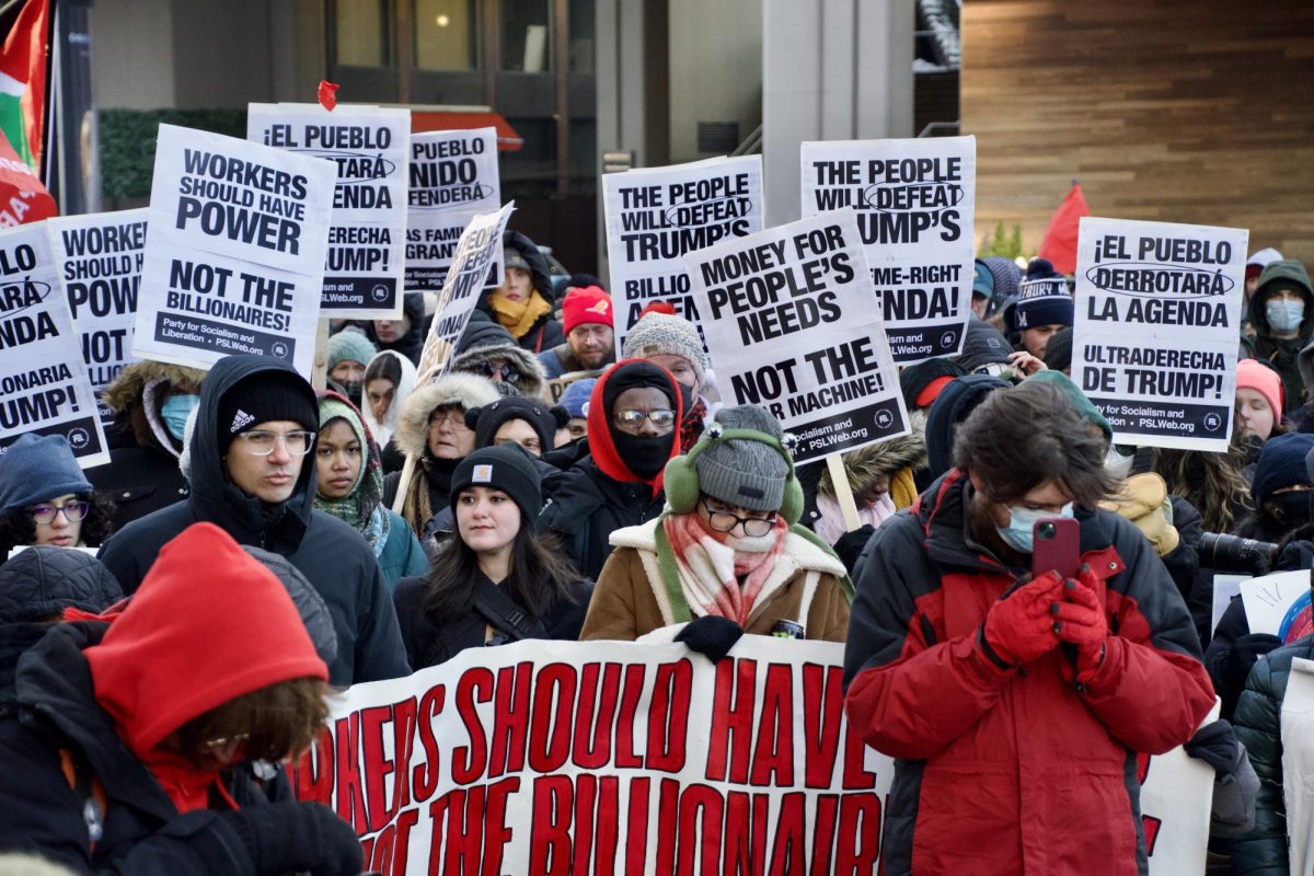 Protesters listen to a speech. Members of the Boston community rallied to fight for issues involving climate change, firing of public sector workers and the war in Palestine.