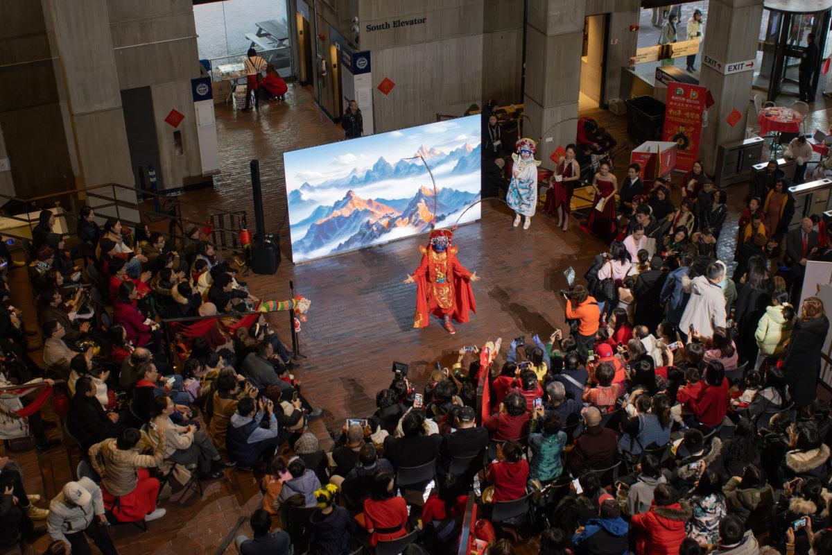 A performer in bright red and gold takes the stage. The act was part of a father-son dance duo.