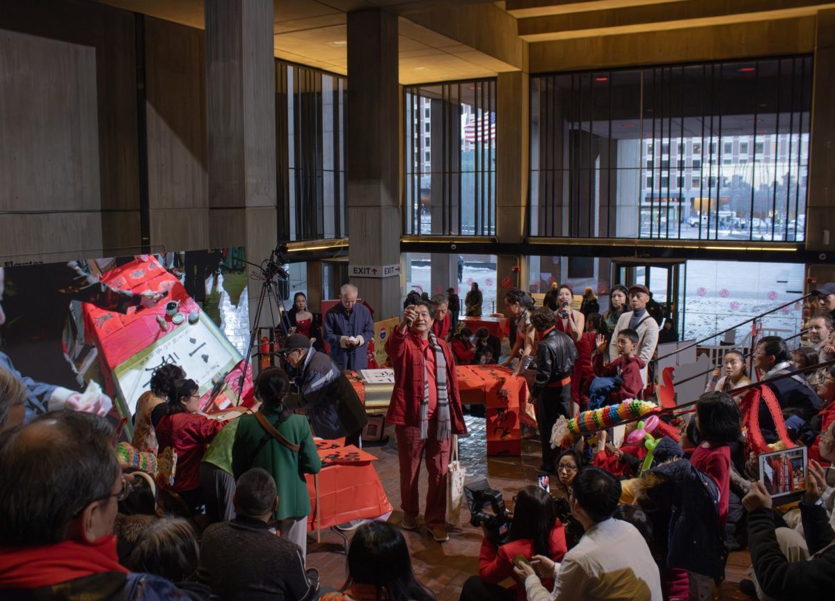 An event host raises the microphone to the crowd. Audience members were asked questions pertaining to the holiday in exchange for small gifts.