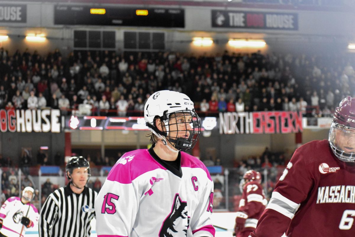 The Doghouse cheers on the team as captain junior forward Jack Williams lines up to play. The Northeastern men's hockey team was handed a disappointing 5-0 loss by the University of Massachusetts Amherst Minutemen Jan. 10 at Matthews Arena