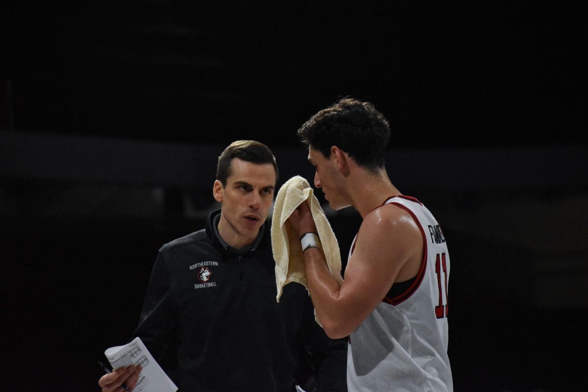 JB Frankel strategizes with coach Brian McDonald Jan. 4. Frankel earned two steals and nine points against Stony Brook Jan. 11.