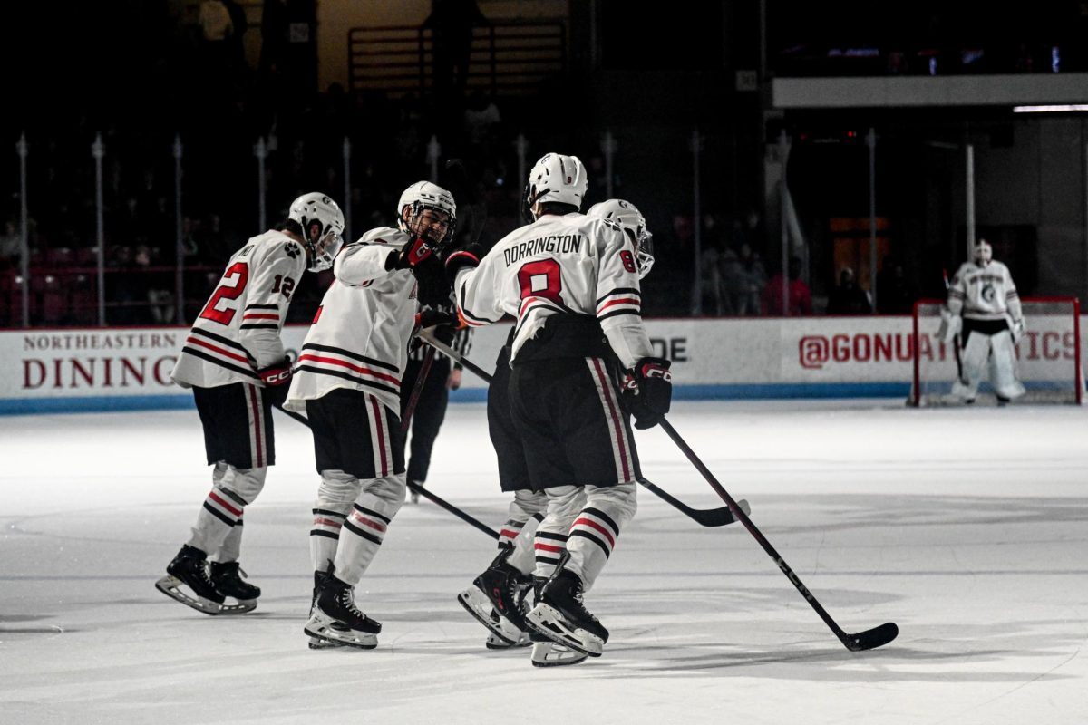 The Huskies celebrate with a fist bump between players. Northeastern scored four points against the Alaska Anchorage Dec. 29.