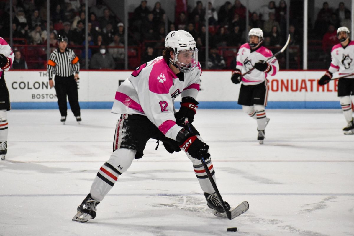 Cam Lund skates up the ice with the puck Jan. 10. Lund scored the second goal for the Huskies in the Jan. 18 game against University of Vermont.