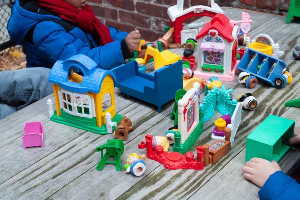 Children play with a toy set. The daycare provided children with toys, books and lessons.