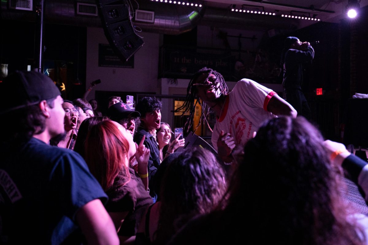 Members of the audience cheer as hip-hop artist Tom The Mail Man flicks his hair Jan. 18. Read more here.