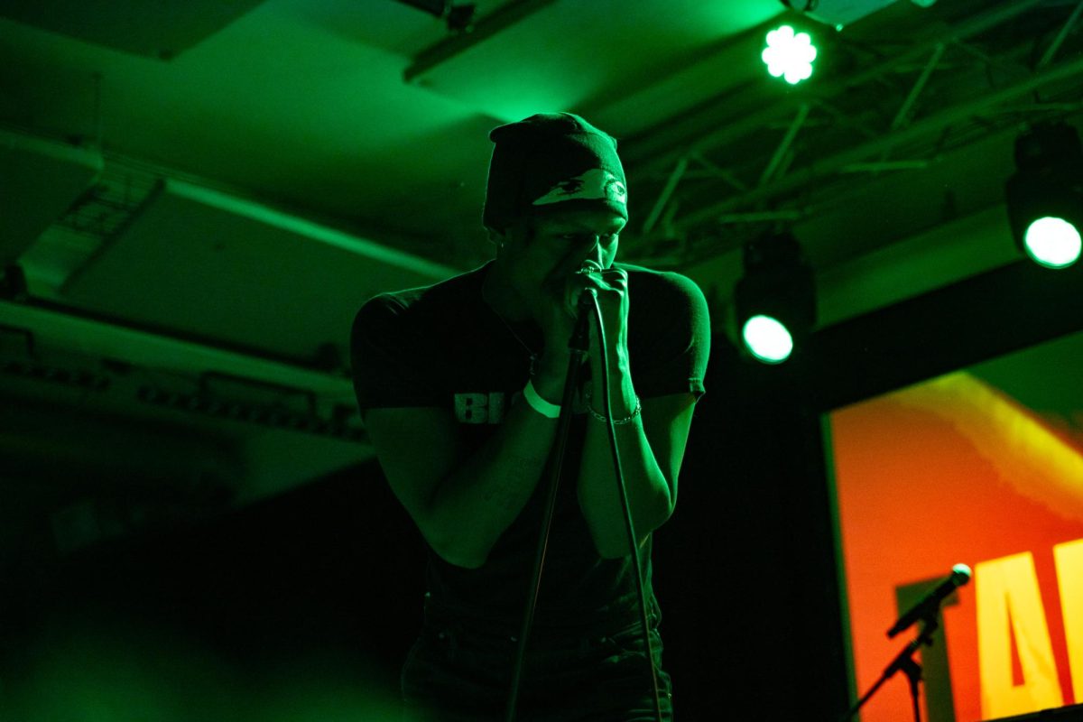 Keeton leans into the microphone as he sings. The crowd followed his chants and instructions throughout his set.