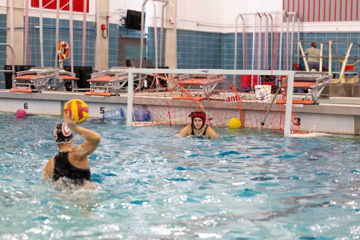 A water polo player takes a shot. Northeastern's women's club water polo team had an undefeated 2023-24 regular season.