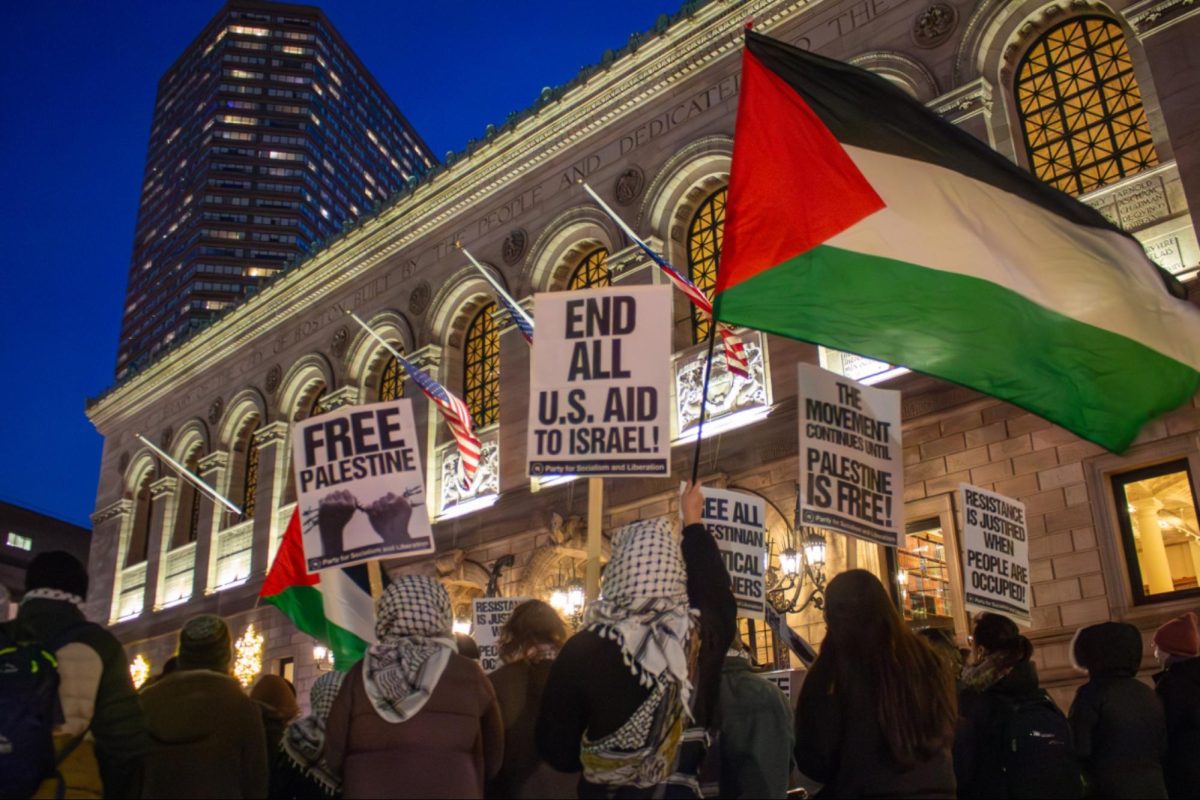 Demonstrators wear Palestinian keffiyehs and raise flags and signs in support of Palestine. Even as the night grew dark and temperatures dropped, rally attendees remained enthusiastic and lively as they chanted and cheered together.  