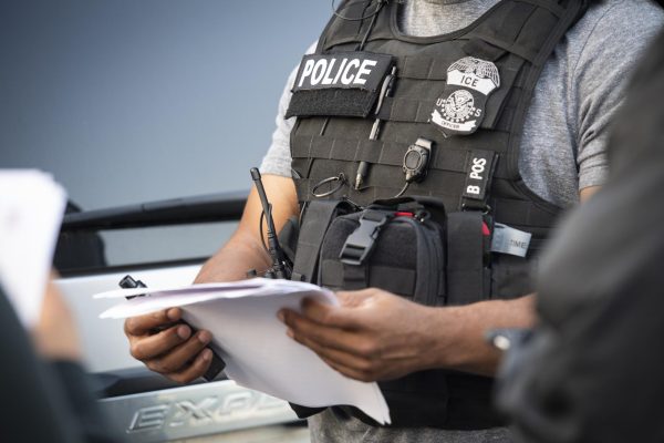 An ICE officer looks over documents in a Virginia field office in May 2019. Northeastern's department of sociology and anthropology provided guidance on potential ICE encounters on campus through an internal email Jan. 31. Photo courtesy flickr.