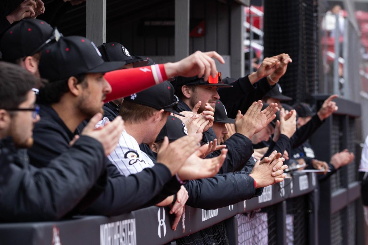 Northeastern baseball cheers on its team from the dugout. The team lost its 21st game to the Red Sox Feb. 21. 