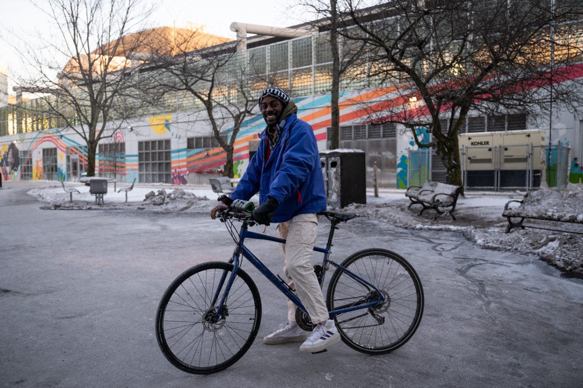 Dylan Mitchell poses for a photo with his bike. He started cycling in the roundabout outside Ruggles in 2022, when he moved up to Boston for work.